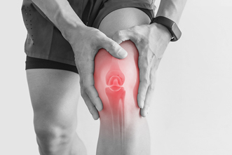 Person holds their knee in pain